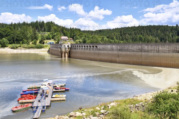 View on Schwarzenbach Dam (German: Schwarzenbachtalsperre) and reservoir in Forbach in the Northern Black Forest in Germany with boat dock and rental on a sunny summer day