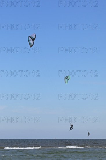Two kitesurfers jumping, Baltic Sea, Falshöft, Pommerby, Schleswig-Holstein, Germany