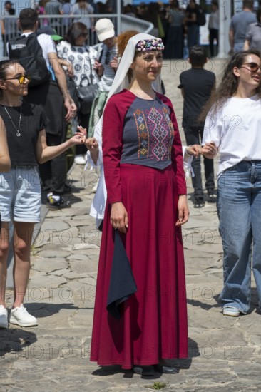 Woman in red traditional dress at an outdoor event, folklore, Tatev, Tatev, Syunik province, Syunik, Armenia