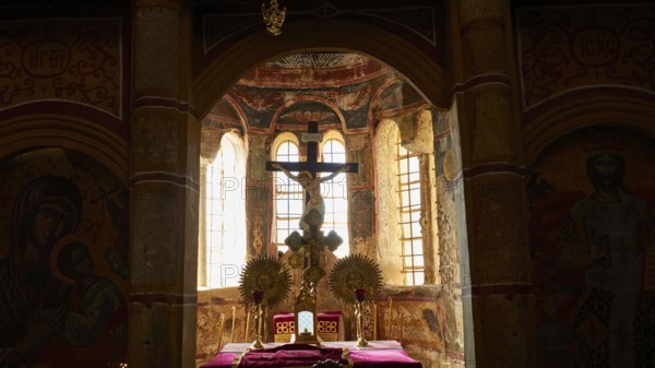 Metropolis, Metropolitan Church of Agios Dimitrios Mystras, An atmospheric church interior with a cross and icons in front of bright windows, Mystras, Mistra, UNESCO World Heritage Site, Medieval Byzantine ruined city, north-west of Sparta, foothills of the Tyagetos Mountains, Peloponnese, peninsula, Greece