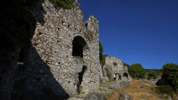 Ancient stone ruins with arches and shadows along a path with a flight of steps, Mystras, Mistra, UNESCO World Heritage Site, Medieval Byzantine ruined city, north-west of Sparta, foothills of the Tyagetos Mountains, Peloponnese, peninsula, Greece