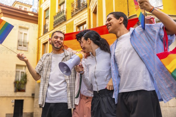 Group of happy young friends celebrating lgbtq plus pride, marching together in a city street with rainbow flags and a megaphone, sharing joy and community spirit