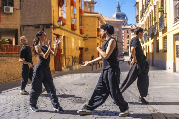 Dance troupe performing a contemporary routine on a cobblestone street, expressing passion and dynamic movement in an urban setting with historic architecture