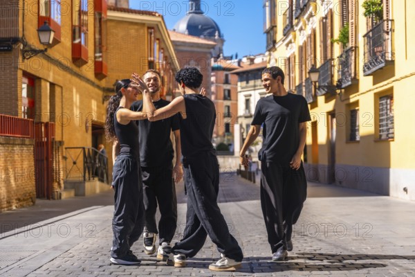 Group of young adult dancers rehearsing a modern dance performance on a cobbled street in a historic european city, enjoying a moment of urban culture