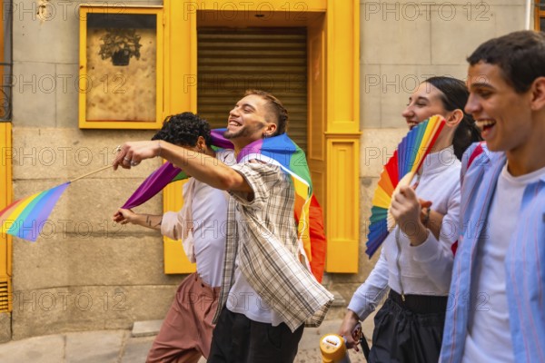 Group of diverse young people actively participating in a pride parade, expressing joy and holding rainbow flags and a fan, celebrating lgbtq plus community, diversity, and inclusion