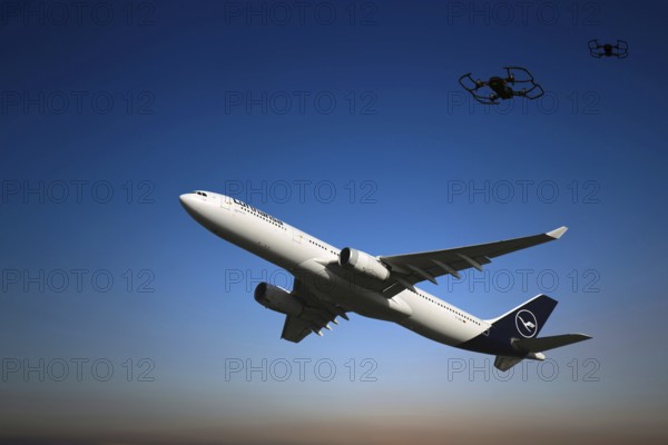 (Photomontage) Lufthansa aircraft taking off in the evening sky, two drones in the background