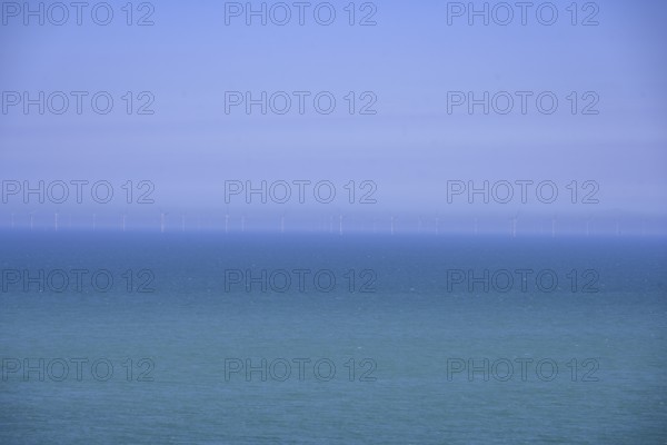 Wind turbines on the sea, hike from Yport to Etretat along the chalk cliff coast, Seine-Maritime department, France