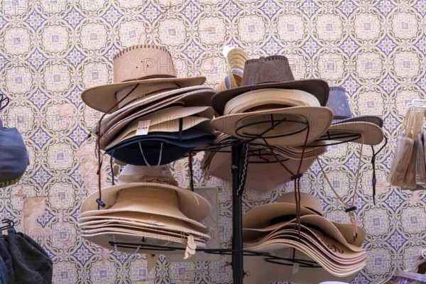 Shop selling various sun hats, old town centre of Tavira, Algarve, Portugal