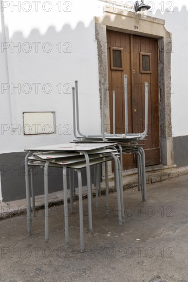 Restaurant furniture, for outdoor catering, tables, chairs, stacked, day off, catering closed, old town of Tavira, Algarve, Portugal