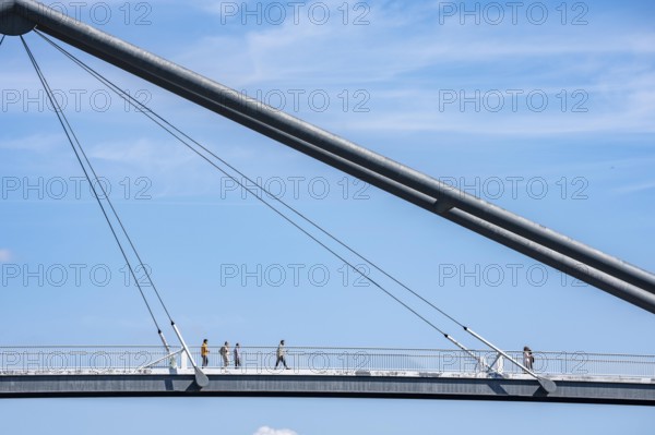 Bridges in Düsseldorf, in the foreground, the pedestrian and cycle bridge over the canal to the inner harbour, media harbour of Düsseldorf, behind it the Rheinkniebrücke, road bridge over the Rhine near Düsseldorf, Germany