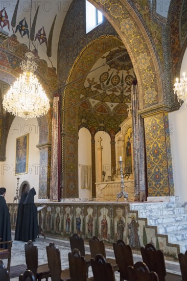Monks pray in the magnificently decorated church with altar and chandelier, Inside the historic, most important Armenian Orthodox cathedral, UNESCO World Heritage Site, Echmiadzin, Ejmiacin, Vagharshapat, Vagarshapat, Vagarshapat, Valaršapat, Vagharshapat, Armavir province, Armenia