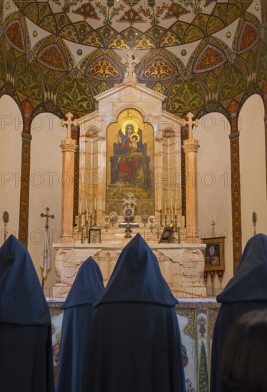 Monks pray in front of an ornately decorated altar with a religious icon, Inside the historic, most important Armenian Orthodox cathedral, UNESCO World Heritage Site, Echmiadzin, Ejmiacin, Vagharshapat, Vagarshapat, Vagarshapat, Valaršapat, Vagharshapat, Armavir province, Armenia