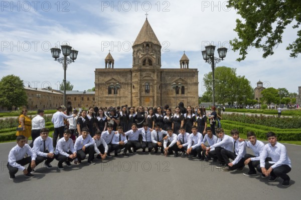 A large group of graduates poses in front of a church, historic, most important Armenian Orthodox cathedral, UNESCO World Heritage Site, Echmiadzin, Echmiadzin, Ejmiacin, Vagharshapat, Vagharshapat, Vagharshapat, Valaršapat, Vagharshapat, Armavir Province, Armenia