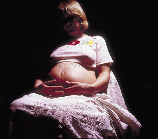 Pregnant woman with her hands on her stomach, Bavaria, Germany