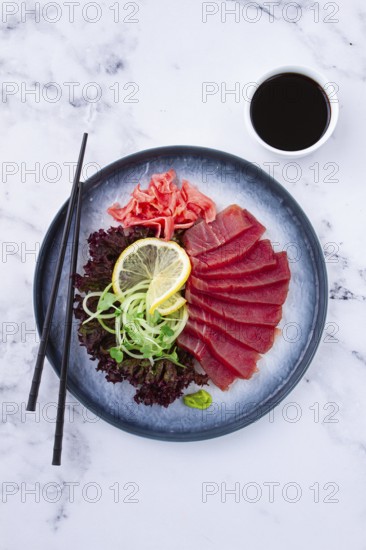 Tuna sashimi, with side dish, on a marble table, homemade, no people