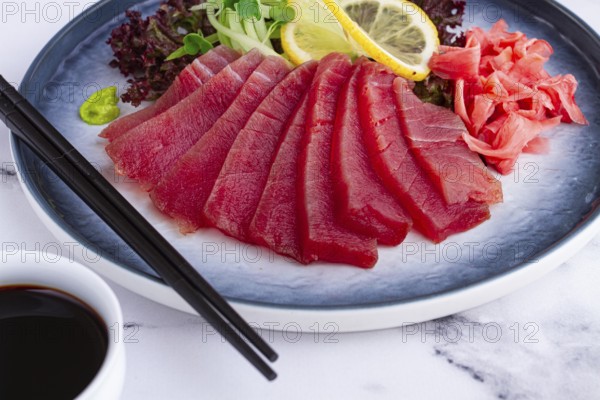 Tuna sashimi, with side dish, on a marble table, homemade, no people