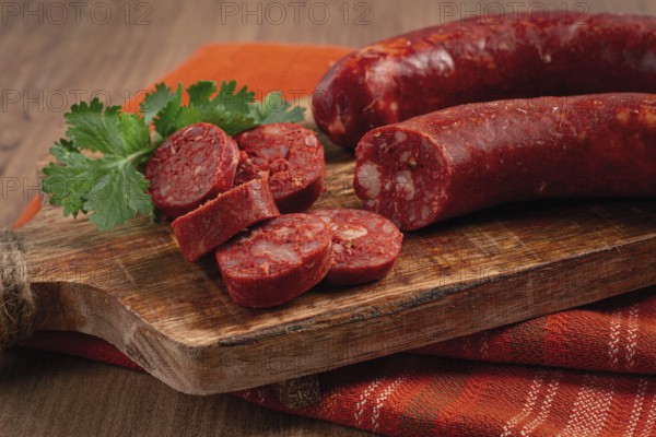 Spicy Chorizo sausage, on a cutting board, on a wooden table