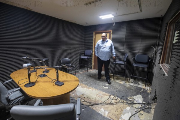 Porcupine, South Dakota - KILI Radio, the voice of the Lakota Nation. Station manager Oitancan Mani Zephier stands in 'Studio B, ' which needs repairs. The station broadcasts in Lakota and English to the Pine Ridge, Cheyenne River, and Rosebud Indian Reservations. Its finances have been hurt by President Trump's dissolution of the Corporation for Public Broadcasting