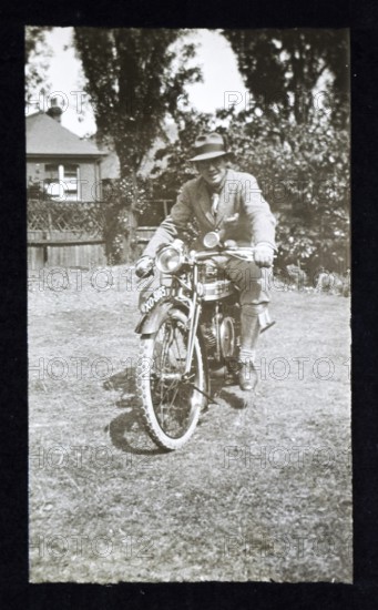 Man sitting on riding motorcycle, England, UK 1920s 1930s