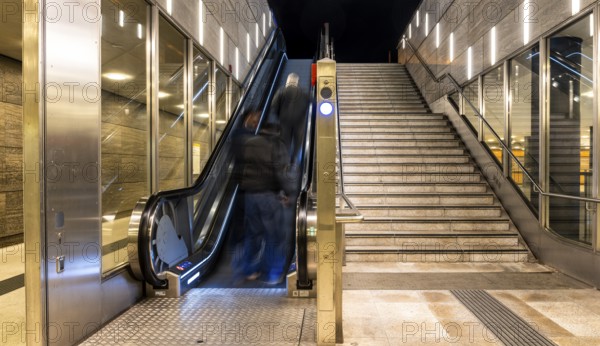 Night photo, long exposure with motion blur, modern underground entrance at Unter den Linden station, contemporary design with stairs and escalator, Berlin, Germany
