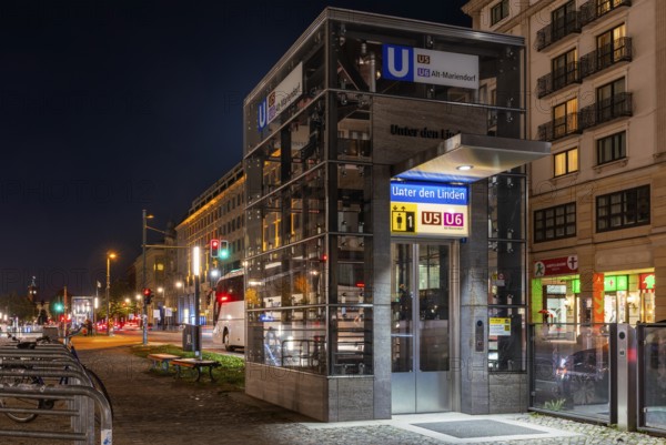Night photo, long exposure with motion blur, modern lift at Unter den Linden underground station, contemporary design with bright lighting, U5 and U6 lines, Berlin, Germany