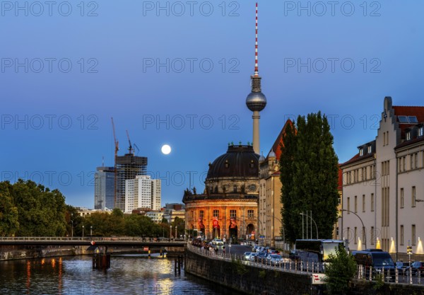 View from the Weidendammer Bridge to the television tower and the Bode Museum, evening light with full moon on the skyline, Berlin, Germany