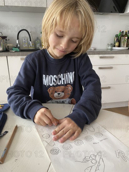 Boy, 6 years, blond, 1st grade, erasing, doing homework in the kitchen, pencil case, Stuttgart, Baden-Württemberg, Germany