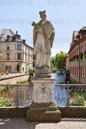 Ettlingen, Germany - August 13th 2025: Statue of Saint John of Nepomuk on Rathausbrücke bridge over River Alb