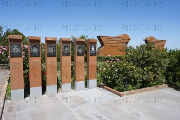 Memorial with portraits of soldiers, surrounded by nature and flowers, Sardarapat Monument, Araks village, Armavir province, Armenia