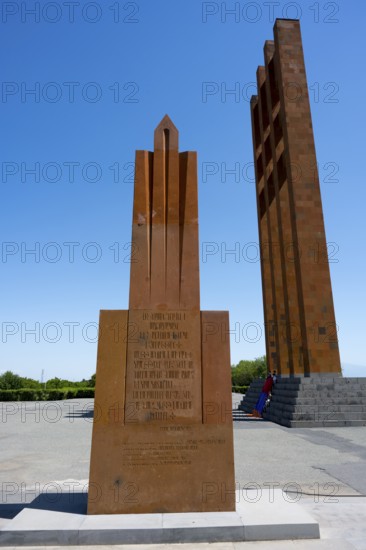 A tall red stone monument against a clear blue sky, Sardarapat Monument, Araks village, Armavir province, Armenia
