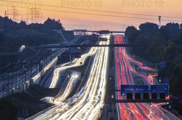 Motorway near Stuttgart with several lanes in the evening with sunset. Heavy traffic with light lanes. BAB 8 motorway near Wendlingen, Baden-Württemberg, Germany
