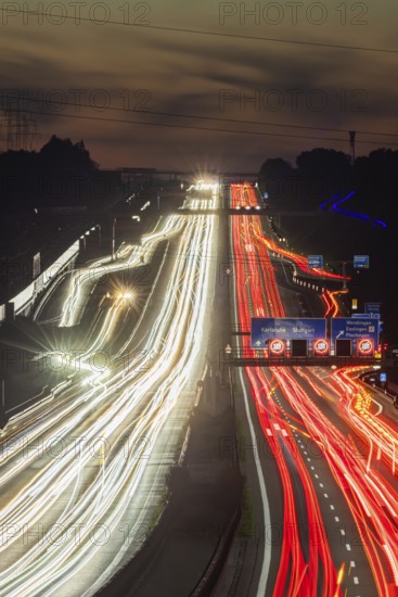 Motorway near Stuttgart with several lanes in the evening with sunset. Heavy traffic with light lanes. BAB 8 motorway near Wendlingen, Baden-Württemberg, Germany