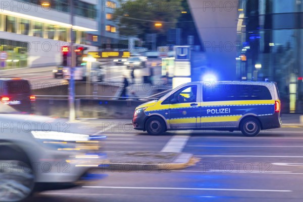 Police vehicle with flashing blue lights in an urban environment. Pulling along. Stuttgart, Baden-Württemberg, Germany
