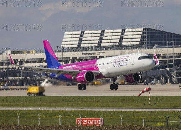Flight operations at Stuttgart Airport with terminal. Aircraft on landing. Aircraft registration number: HA-LGR, Wizz Air, Airbus A321neo. Stuttgart, Baden-Württemberg, Germany