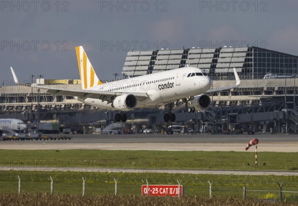 Flight operations at Stuttgart Airport with terminal. Aircraft on landing. Aircraft registration number: LZ-FBK, Condor, Airbus A320-200, Stuttgart, Baden-Württemberg, Germany