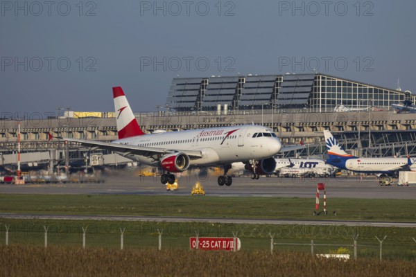 Flight operations at Stuttgart Airport with terminal. Aircraft landing. Aircraft registration: OE-LBR Austrian Airlines Airbus A320-200. Stuttgart, Baden-Württemberg, Germany