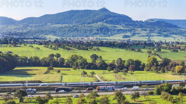 Landscape in the foothills of the Swabian Alb with the new Deutsche Bahn AG railway line from Stuttgart to Ulm. Two ICE trains meeting. Kirchheim unter Teck, Baden-Württemberg, Germany