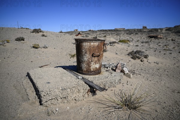 Rusted bucket in the desert sand, Pomona, restricted diamond area, near Lüderitz, Karas region, Namibia