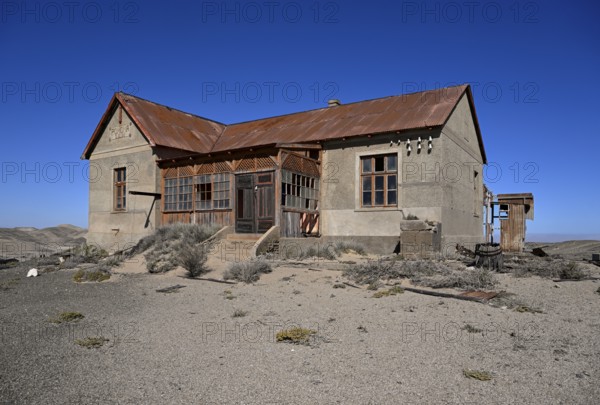 Dilapidated building in the desert sand, Pomona, restricted diamond area, near Lüderitz, Karas region, Namibia