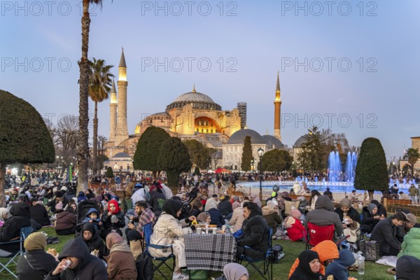 Muslims at an evening Ramadan picnic in the park in front of the Hagia Sophia mosque in Istanbul, Turkey