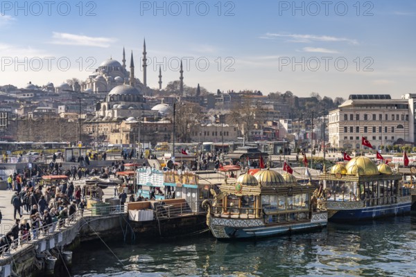 Restaurant boats on the banks of Eminönü, Rüstem Pasha Mosque and Suleymaniye Mosque, Istanbul, Turkey