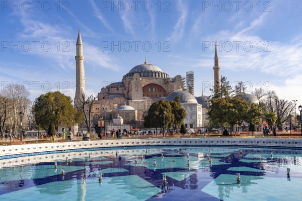 Fountain in Sultan Ahmet Park and the present-day mosque Hagia Sophia or Church of St Sophia, former Byzantine church and museum in Istanbul, Turkey
