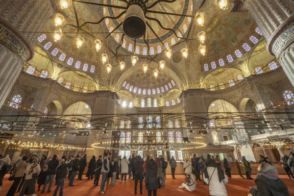 Visitors to the Blue Mosque or Sultan Ahmed Mosque in Istanbul, Turkey