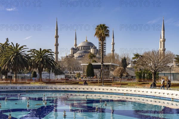 Fountain in Sultan Ahmet Park and the Blue Mosque or Sultan Ahmed Mosque in Istanbul, Turkey