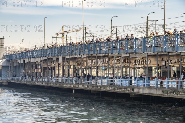 Anglers and restaurants on the Galata Bridge in Istanbul, Turkey
