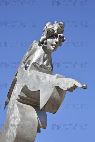 Sculpture guardian angel by Jürgen Goertz, modern art, water basin, fountain, bizarre shining angel with index finger, view from below, silver, pointing, pointing, symbol, aluminium, free-standing, fountain gallery, Adenauerplatz, Wiesloch, Baden-Württemberg, Germany