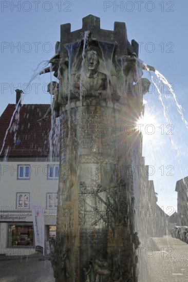 Town hall fountain with reliefs and figures by Klaus Ringwald 1998 in backlight, bronze sculptures, water features, market square, Hechingen, Swabian Alb, Baden-Württemberg, Germany