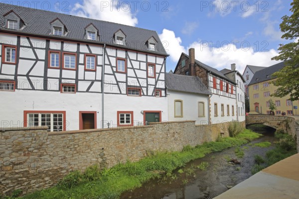 Historic half-timbered house Alte Mälzerei on the Erft stream and stone arch bridge, Bad Münstereifel, Ahrgebirge, Eifel, North Rhine-Westphalia, Germany