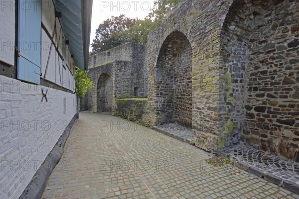 Historic town wall and half-timbered house with shutters, archways, Turmstraße, Bad Münstereifel, Ahrgebirge, Eifel, North Rhine-Westphalia, Germany