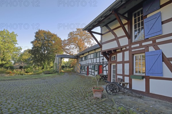 Half-timbered house with colourful shutters and entrance, built 14th century, inner courtyard, archway, moated castle, Kleeburg, Weidesheim, Euskirchen, Vordereifel, Eifel, North Rhine-Westphalia, Germany